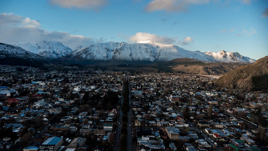 Stunning aerial panorama of Esquel, Argentina, framed by the snow-capped Andes mountains.